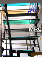 View from below on staircase in apartment with different coloured stages from glass triplex