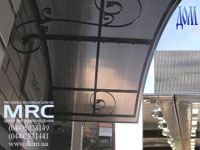 Porte-cochere with forged elements